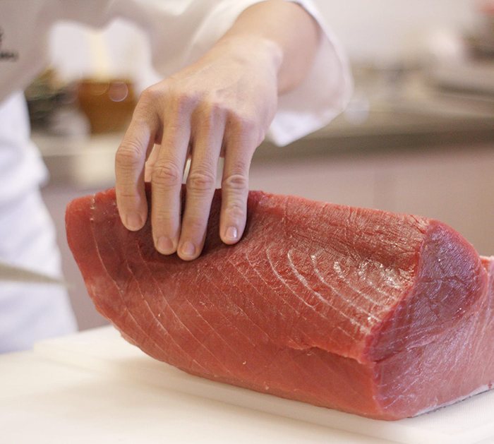A whole loin of bluefin tuna being prepared