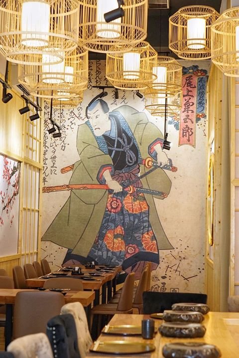 The Kazumasa dining room with a painted samurai mural along one wall